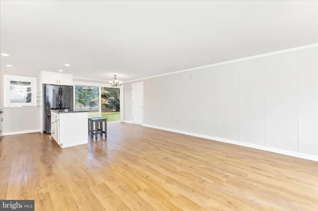 a view of a room with wooden floor and a window