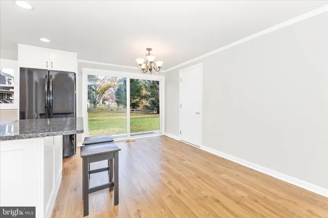 a view of an empty room with a fireplace and a large window