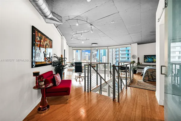 a living room with lots of furniture and wooden floor