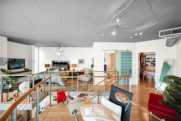 a view of a balcony with wooden floor and windows