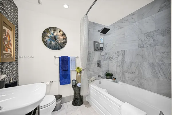 a bathroom with a toilet a sink and a mirror