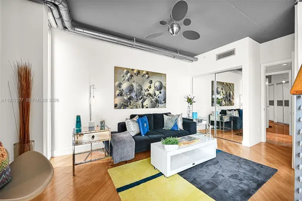 a living room with furniture and floor to ceiling windows