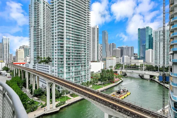 a living room with furniture and floor to ceiling windows