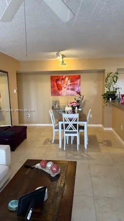 a living room with furniture gym equipment and a window