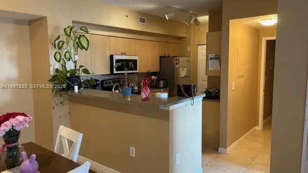 a kitchen with a sink appliances and cabinets