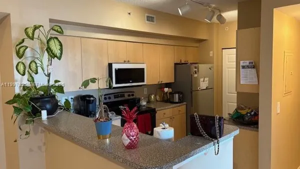 a kitchen with a refrigerator stove and microwave