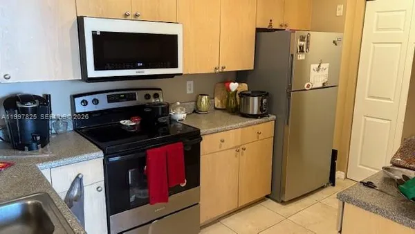 a kitchen with a stove and a microwave