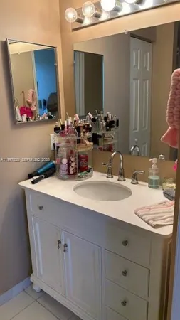 a bathroom with a toilet and a mirror