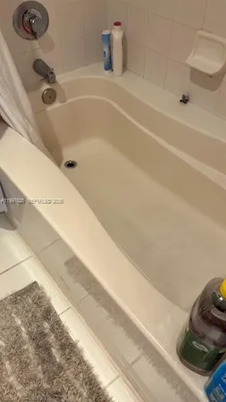 a bathroom with a sink vanity and mirror