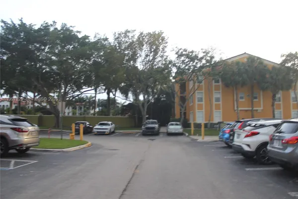 a view of the street with parked cars