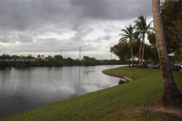 a view of a lake with houses in background