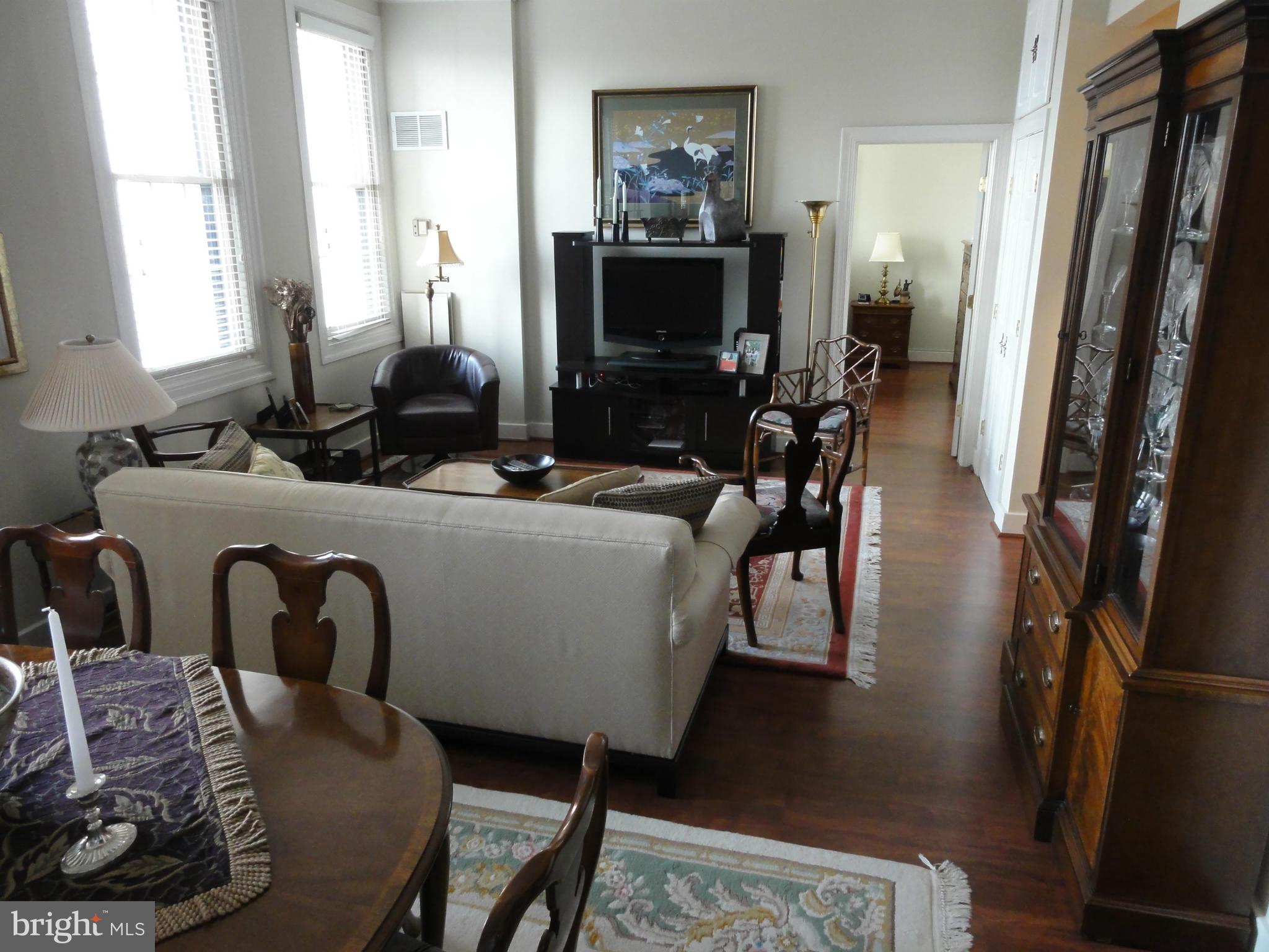 1 East Chase Street, Unit 814 Baltimore, MD 21202 - Photo 11 of 27 a living room with furniture and a flat screen tv