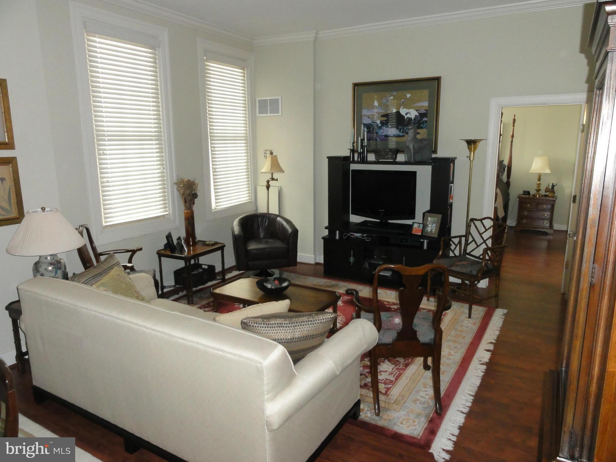 1 East Chase Street, Unit 814 Baltimore, MD 21202 - Photo 13 of 27 a living room with furniture and a flat screen tv