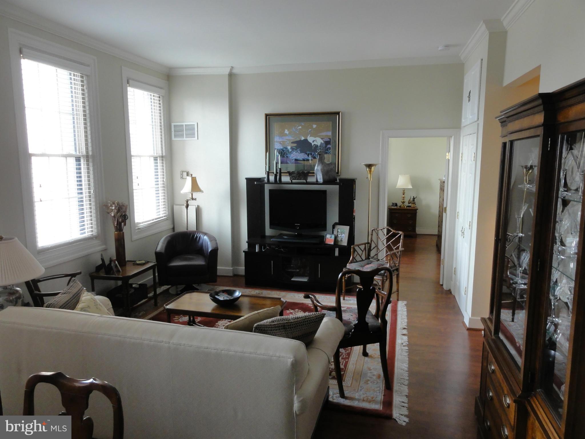 1 East Chase Street, Unit 814 Baltimore, MD 21202 - Photo 14 of 27 a living room with furniture and a flat screen tv