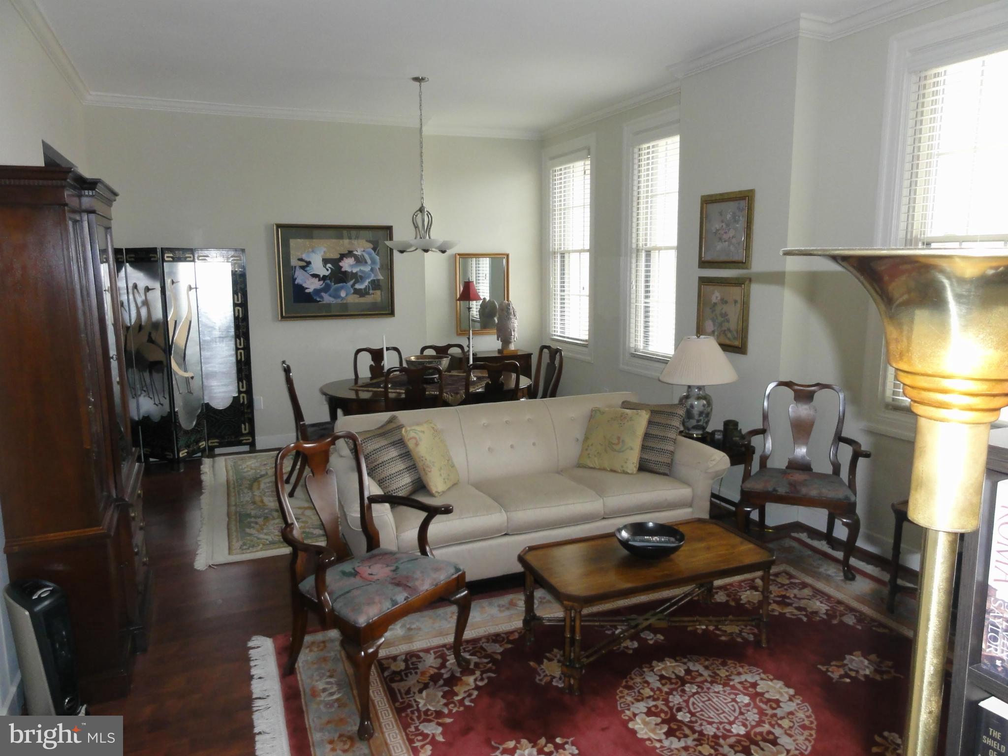 1 East Chase Street, Unit 814 Baltimore, MD 21202 - Photo 15 of 27 a living room with furniture and a lamp