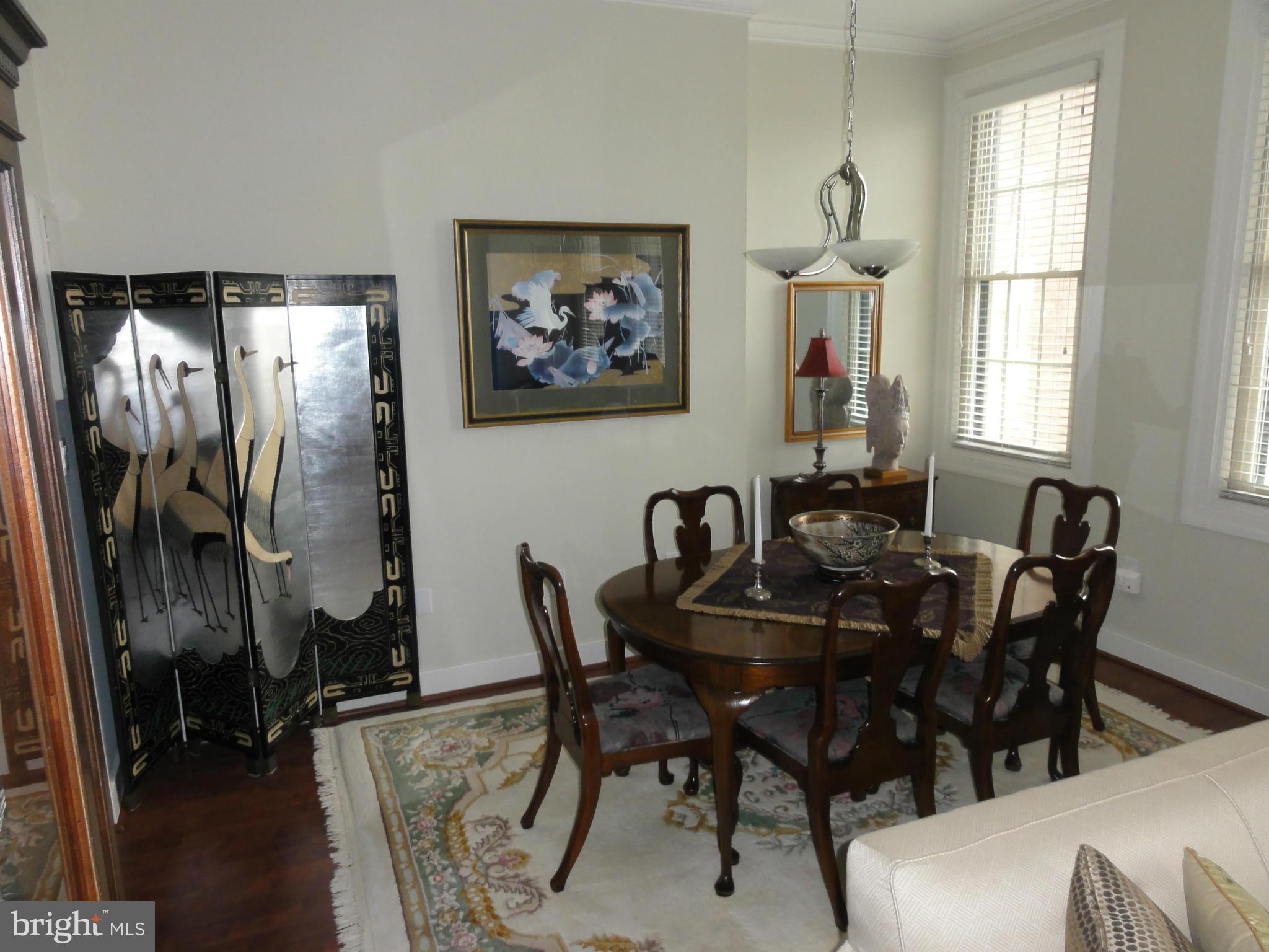 1 East Chase Street, Unit 814 Baltimore, MD 21202 - Photo 16 of 27 a view of a dining room with furniture and window