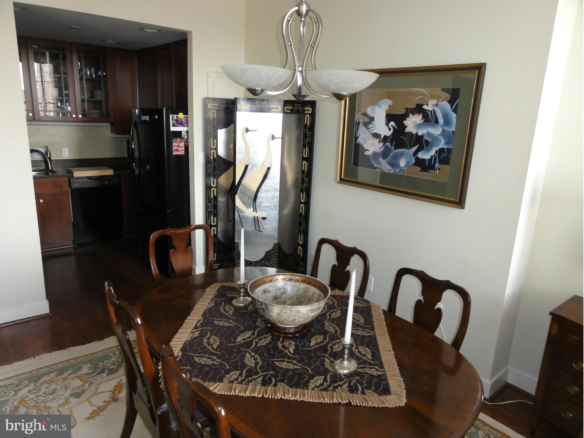 1 East Chase Street, Unit 814 Baltimore, MD 21202 - Photo 17 of 27 a view of a dining room with furniture window and wooden floor