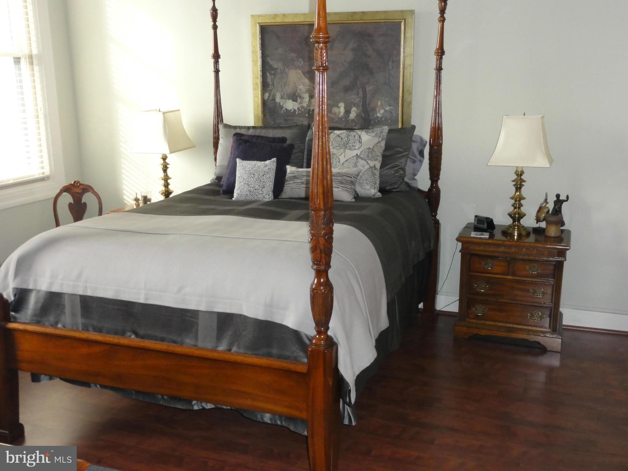1 East Chase Street, Unit 814 Baltimore, MD 21202 - Photo 20 of 27 a bedroom with a bed and a lamp on table