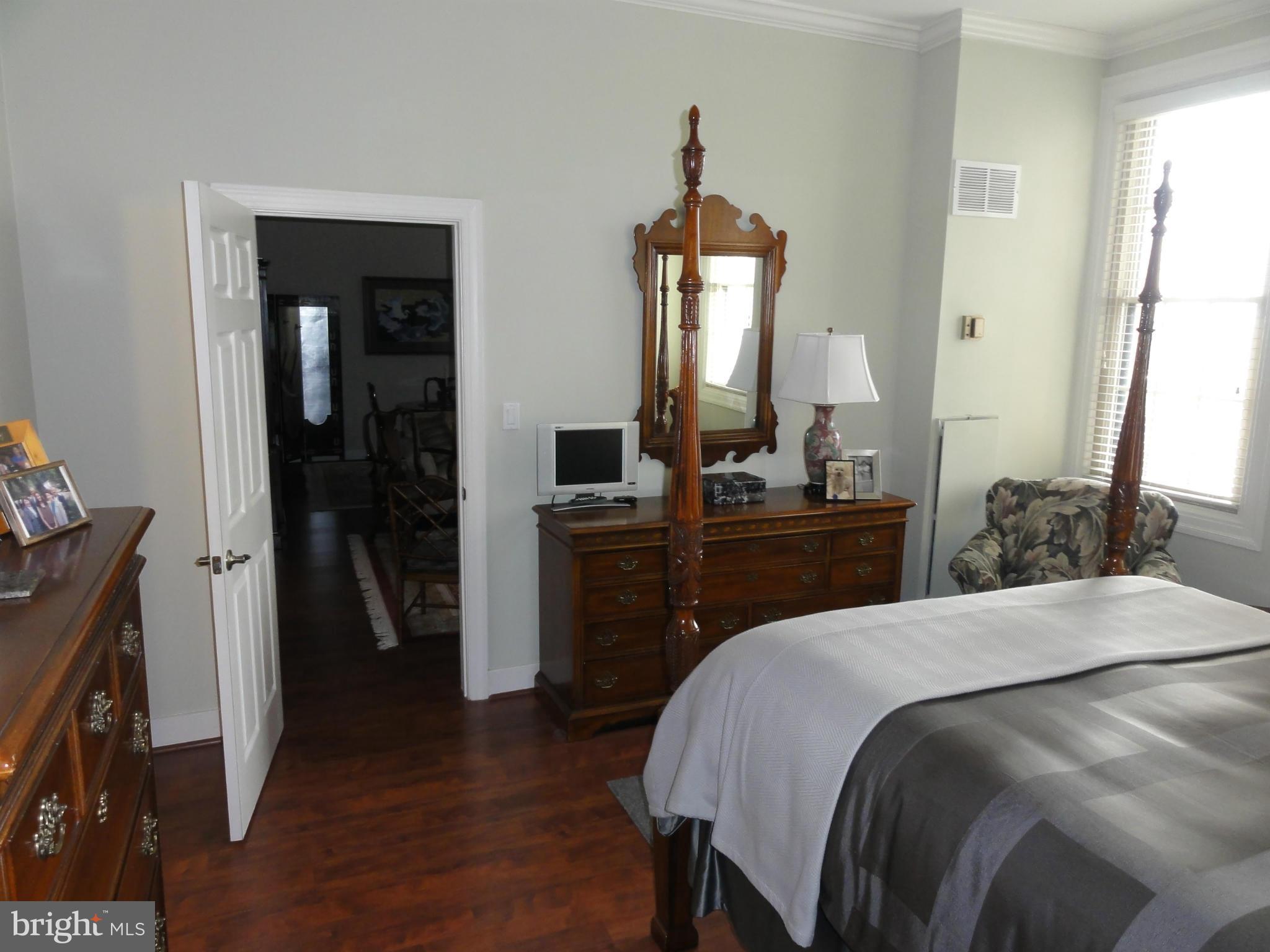 1 East Chase Street, Unit 814 Baltimore, MD 21202 - Photo 23 of 27 a bedroom with a bed and a mirror on dresser