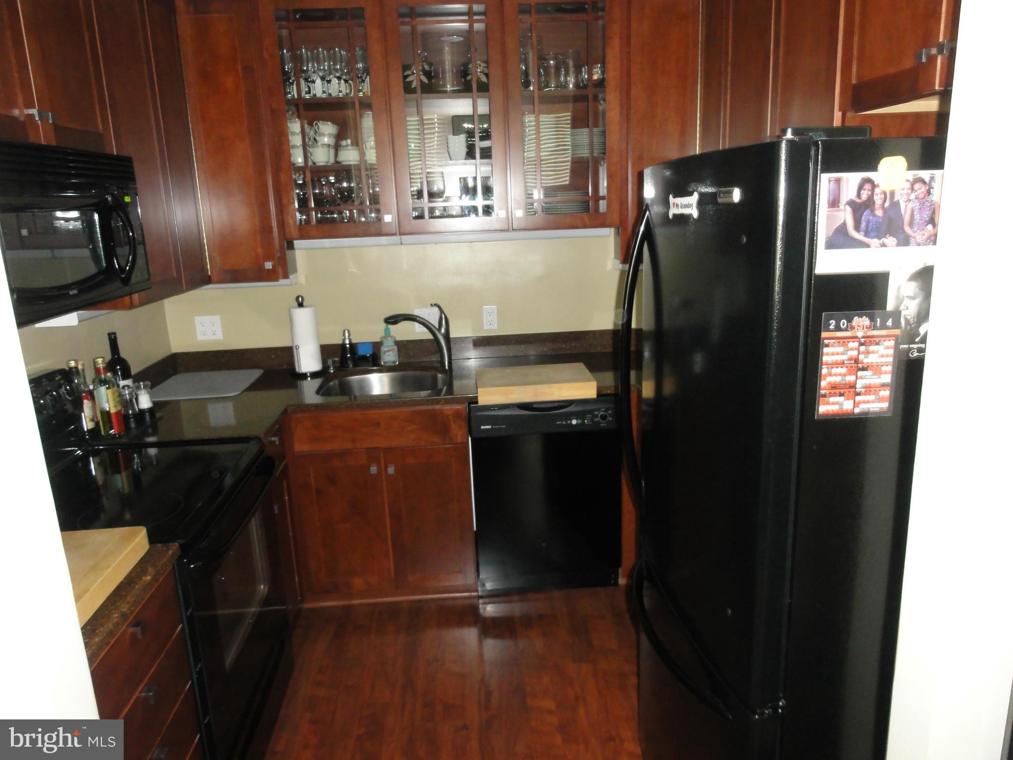 1 East Chase Street, Unit 814 Baltimore, MD 21202 - Photo 6 of 27 a kitchen with a sink stainless steel appliances and cabinets