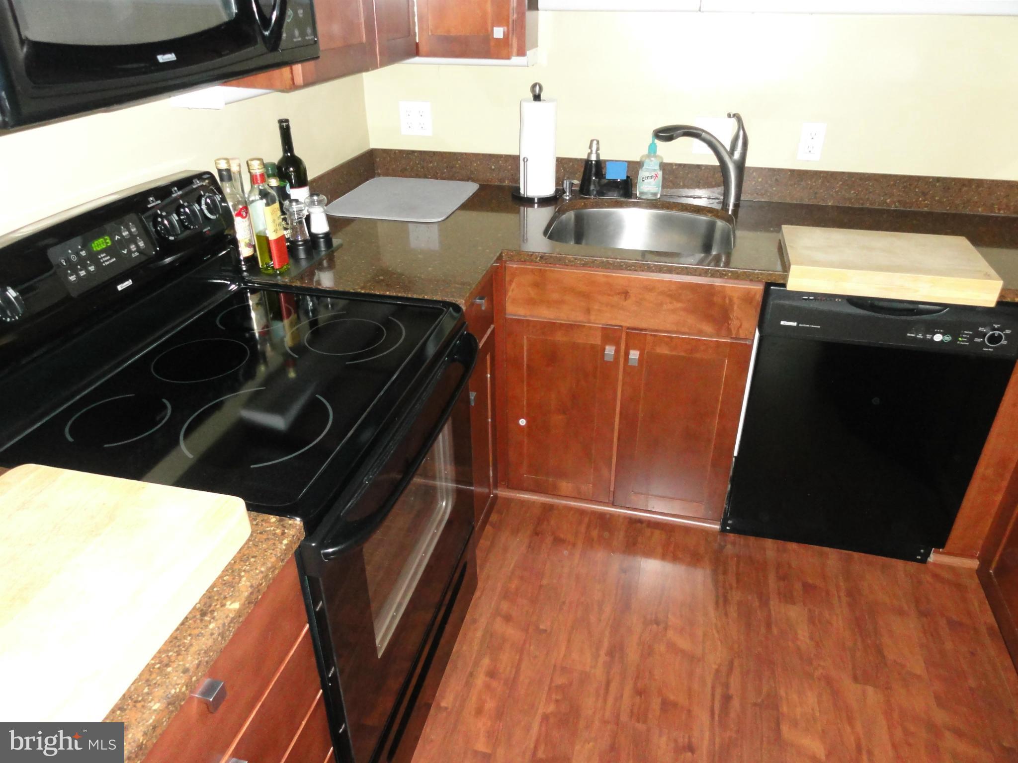 1 East Chase Street, Unit 814 Baltimore, MD 21202 - Photo 9 of 27 a kitchen with a sink and a stove top oven