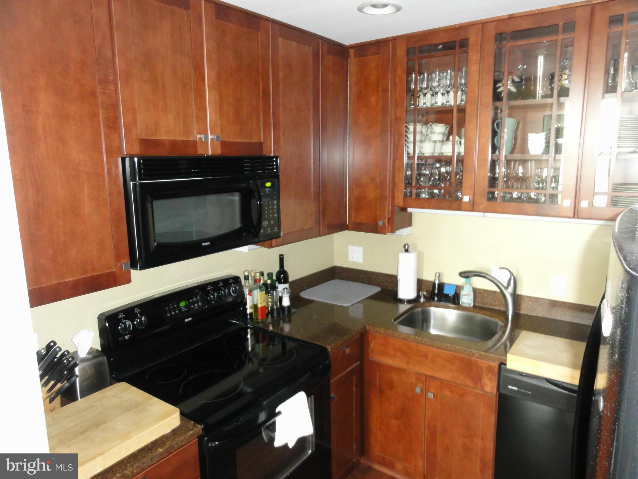 1 East Chase Street, Unit 814 Baltimore, MD 21202 - Photo 10 of 27 a kitchen with a sink stove and microwave