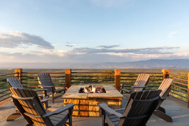 a kitchen with a table chairs stove and wooden floor