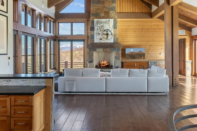 a living room with furniture and floor to ceiling windows