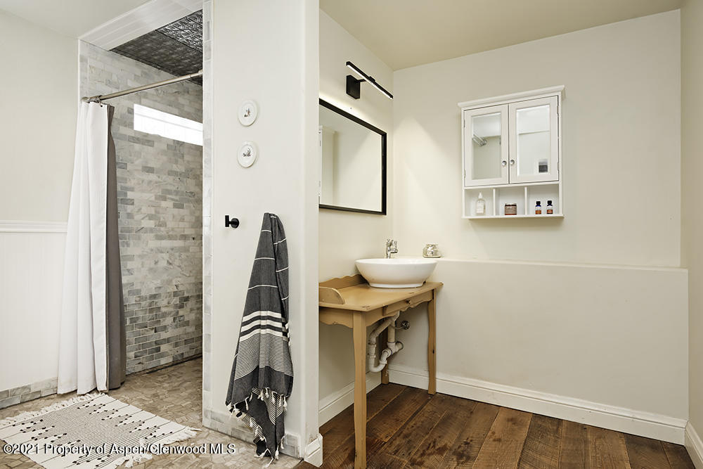 113 West State Street Marble, CO 81623 - Photo 16 of 28 a bathroom with a sink a mirror and a shower