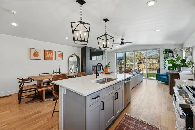 a view of a kitchen area kitchen island furniture wooden floor and a chandelier