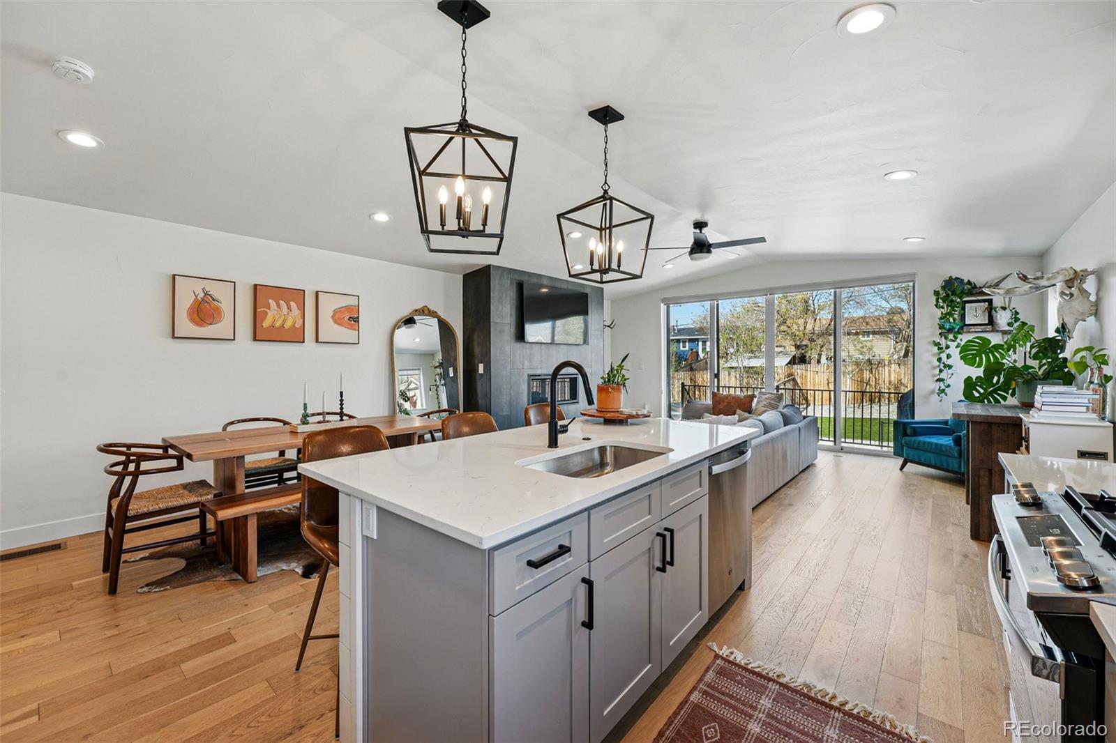 949 Raleigh Street, Unit 2 Denver, CO 80204 - Photo 11 of 42 a view of a kitchen area kitchen island furniture wooden floor and a chandelier