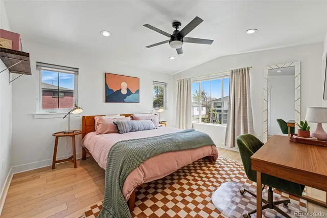 a bedroom with a bed a couch and a window