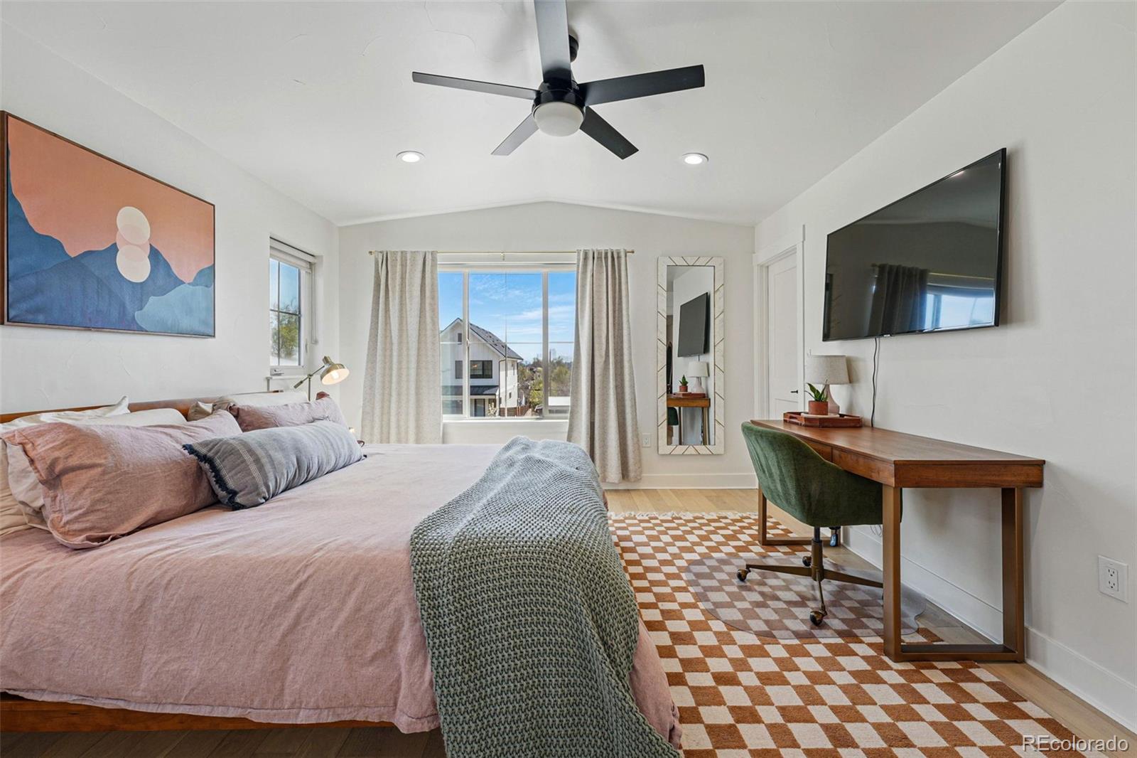 949 Raleigh Street, Unit 2 Denver, CO 80204 - Photo 17 of 42 a bedroom with a bed and a flat screen tv