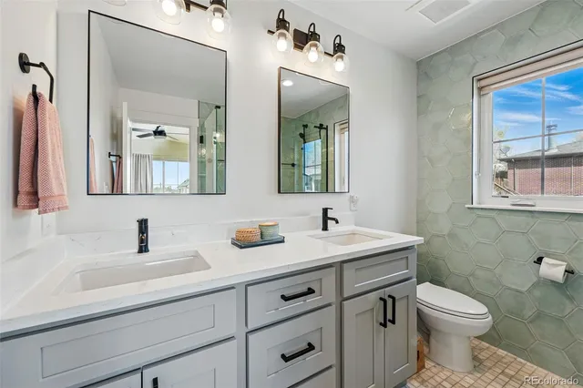 a bathroom with a toilet sink and mirror