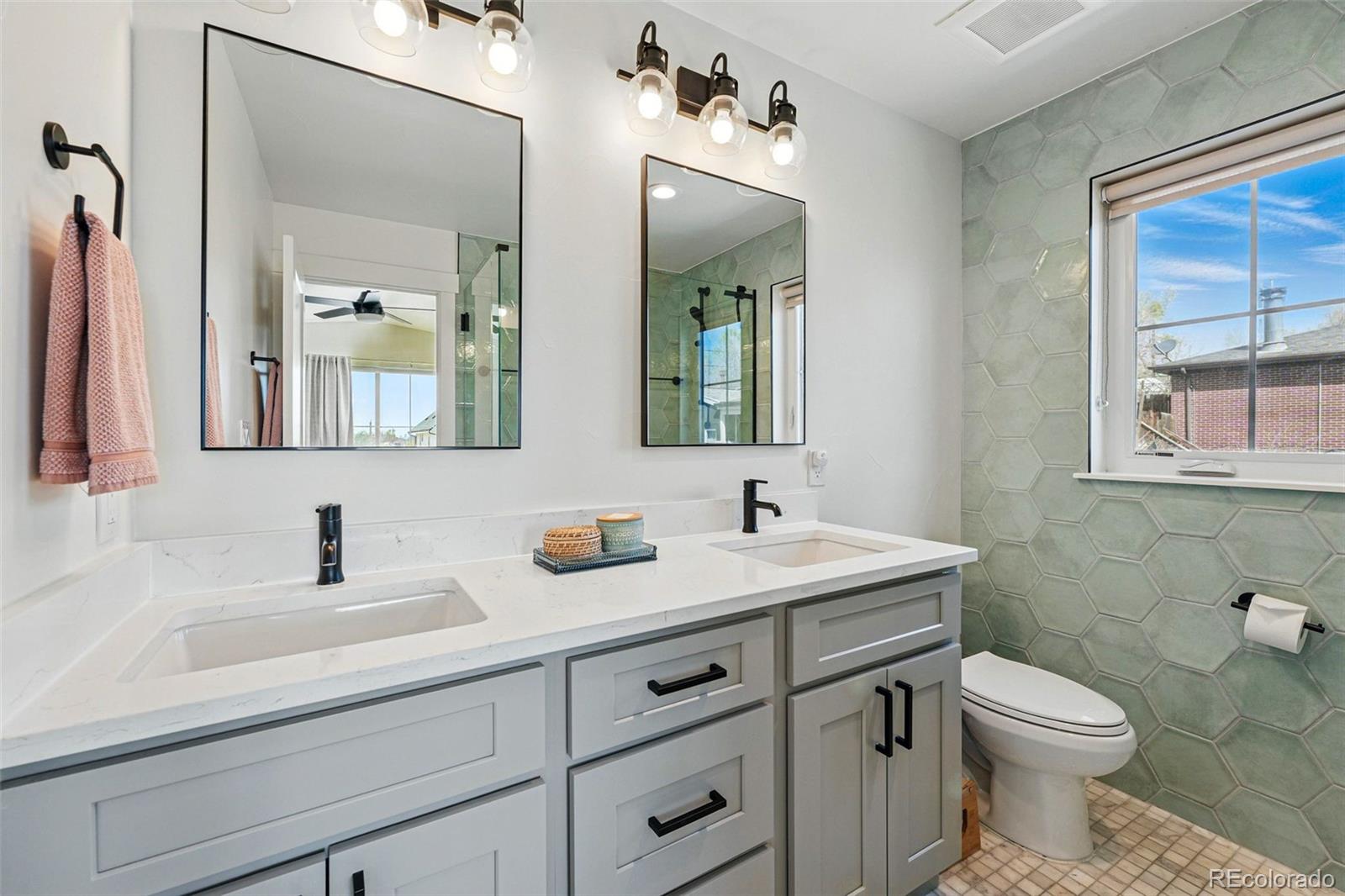 949 Raleigh Street, Unit 2 Denver, CO 80204 - Photo 20 of 42 a bathroom with a toilet sink and mirror
