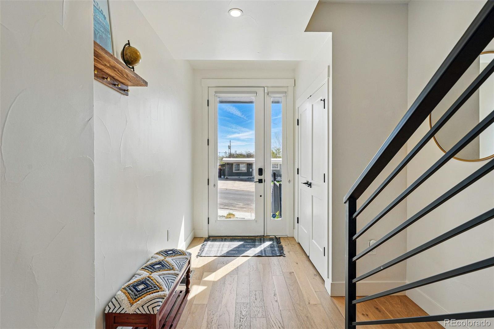 949 Raleigh Street, Unit 2 Denver, CO 80204 - Photo 2 of 42 a view of a hallway with wooden floor and staircase