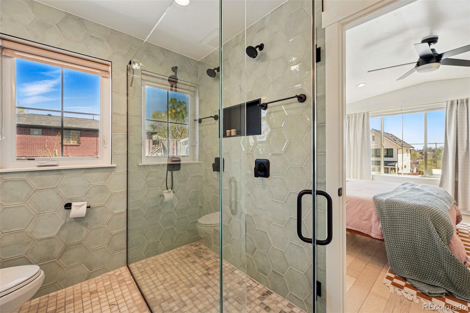 949 Raleigh Street, Unit 2 Denver, CO 80204 - Photo 21 of 42 a bathroom with a granite countertop sink mirror and shower