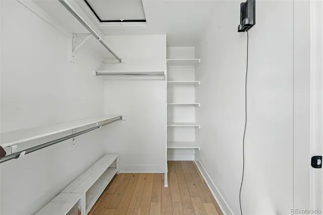 a view of walk in closet with empty racks
