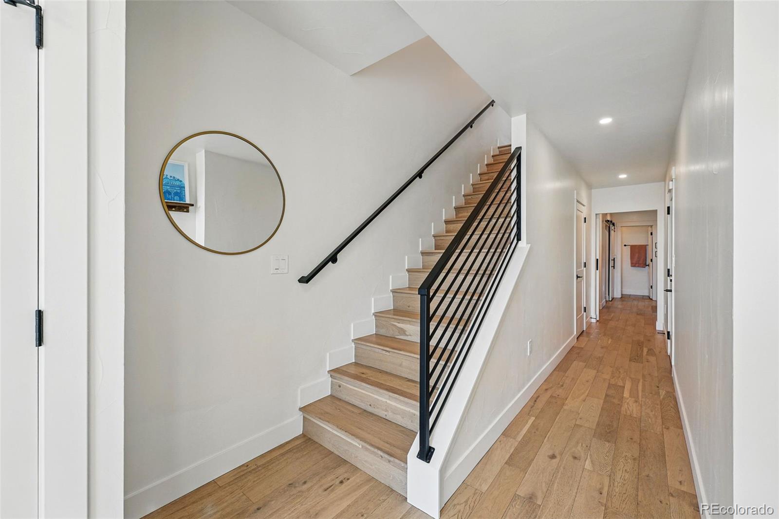 949 Raleigh Street, Unit 2 Denver, CO 80204 - Photo 24 of 42 a view of a hallway with wooden floor and staircase