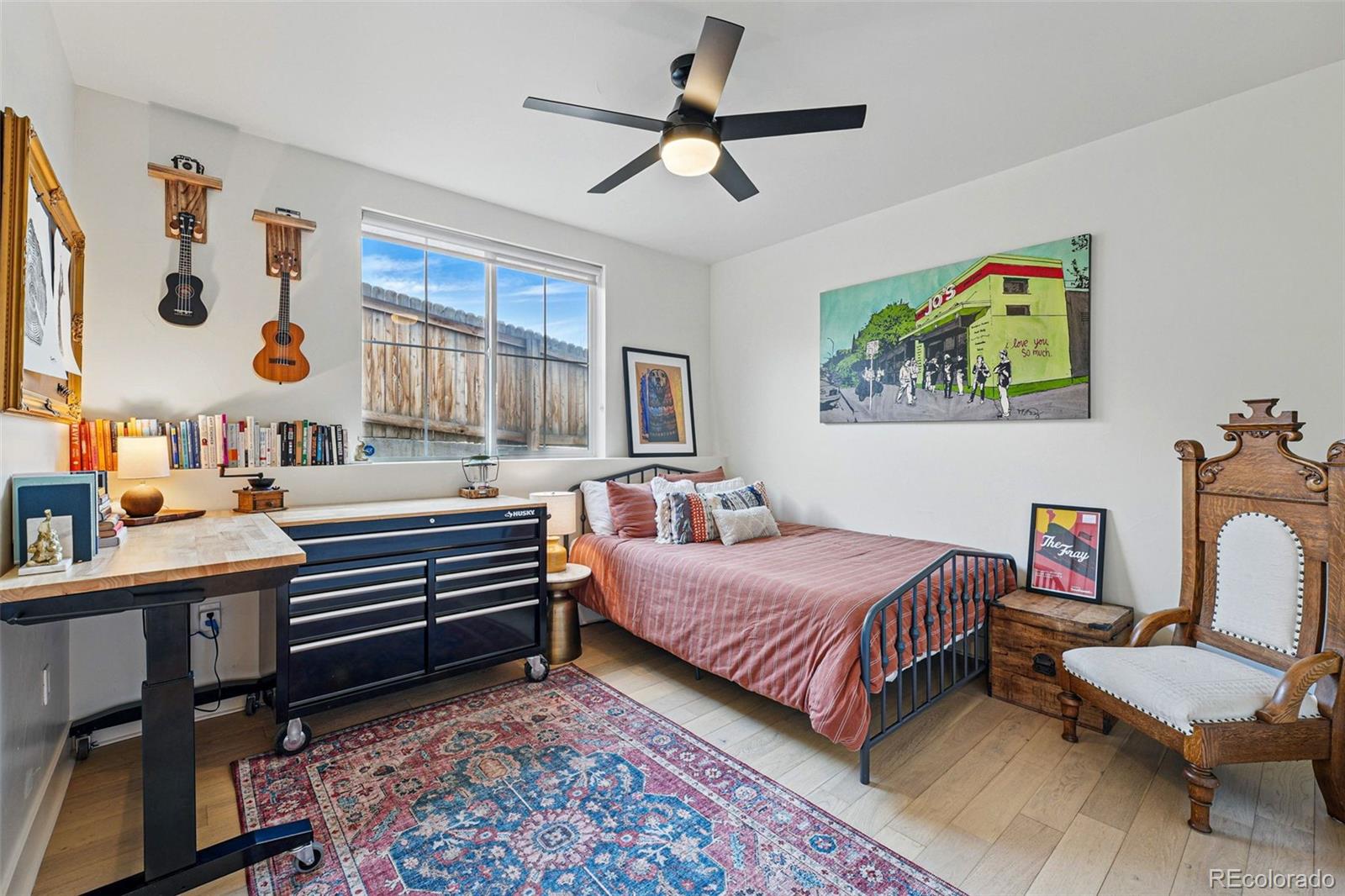 949 Raleigh Street, Unit 2 Denver, CO 80204 - Photo 26 of 42 a bedroom with a bed and a chandelier