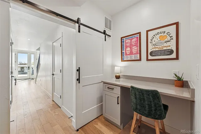 a view of a workspace with furniture and a table