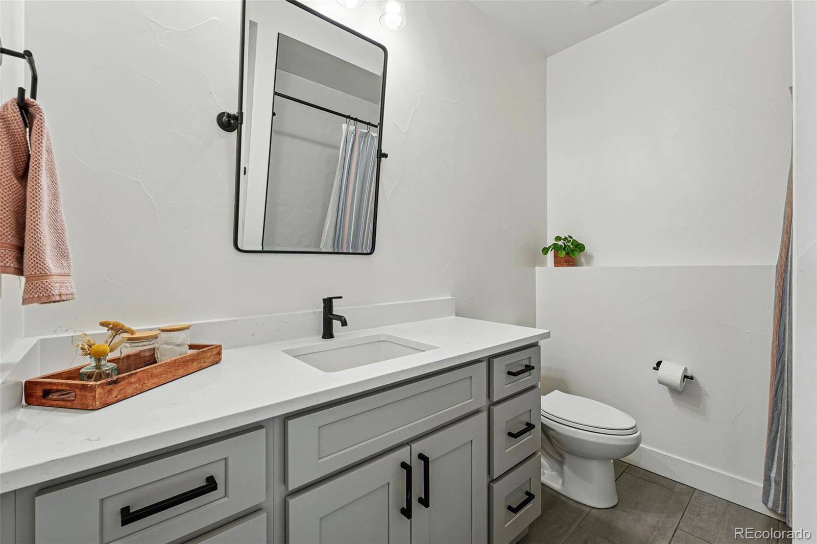 949 Raleigh Street, Unit 2 Denver, CO 80204 - Photo 28 of 42 a bathroom with a toilet sink and mirror