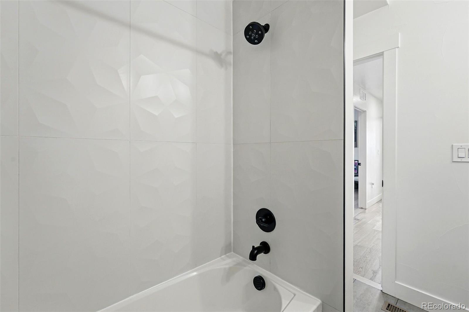 949 Raleigh Street, Unit 2 Denver, CO 80204 - Photo 29 of 42 a bathroom with a tub and shower