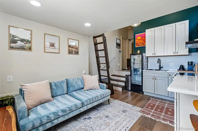a living room with furniture and kitchen view