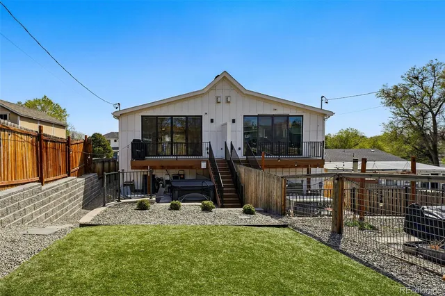 a view of a house with backyard porch and sitting area