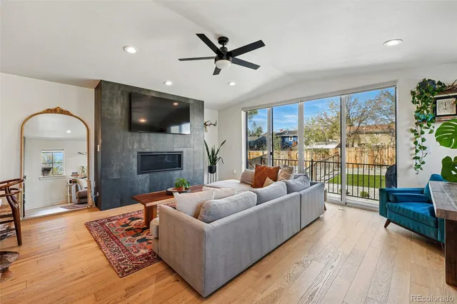 a living room with furniture a flat screen tv and a fireplace