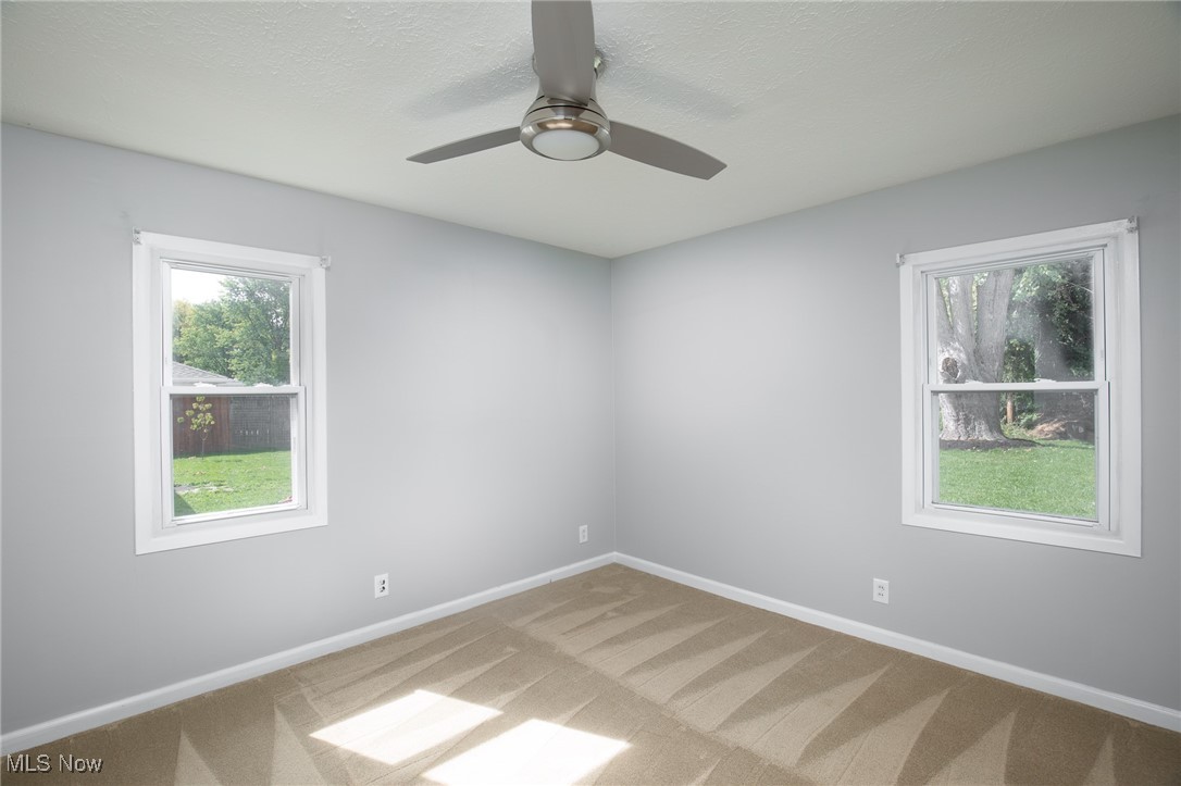 4782 Belle Meadow Road Mentor, OH 44060 - Photo 15 of 22 Carpeted empty room with ceiling fan and a textured ceiling