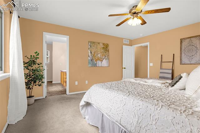 11045 Falling Star Road Fountain, CO 80817 - Photo 23 of 39 Bedroom featuring visible vents, a ceiling fan, baseboards, and light carpet