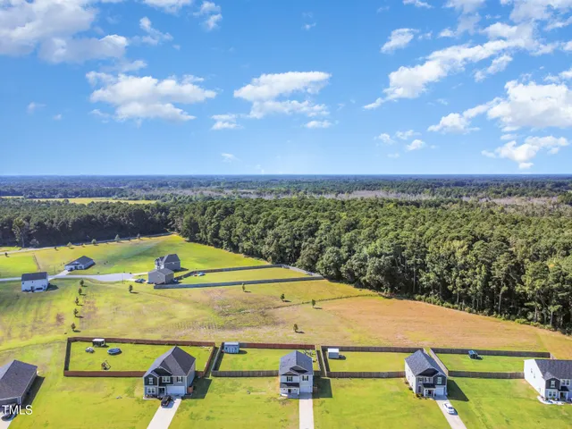 a living room with furniture and view of kitchen