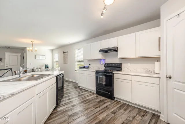 a bedroom with a bed a flat screen tv and a couch